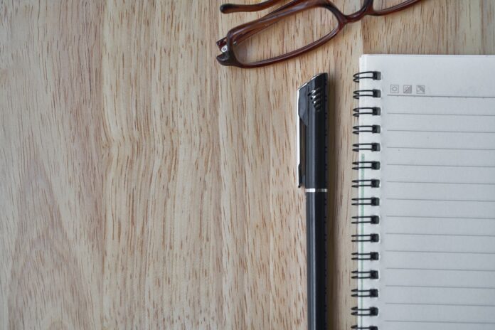notebook, pen, glasses