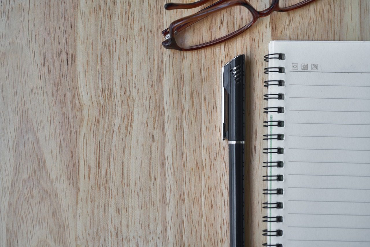 notebook, pen, glasses
